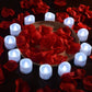 Frendorf | 12-teilig: LED Teelichtkerze mit 100 Stück Fake Rosenblüten