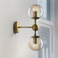 Frendorf | 1/2-Head Global Wandmontage Licht mit Amber Glas Schirm Modernistische Wandlampe Beleuchtung in Gold für Schlafzimmer