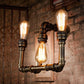 Frendorf | Industrielle Exposed Wandlampe mit Rohrdesign 3 Köpfe Schmiedeeisen Wandleuchte in antikem Messing für Flur