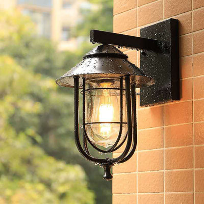 Frendorf | Laterne-förmige Balkon-Wandlampe Lager Metall 1 Kopf Wettergegerbtes Kupfer/schwarz Wandbeleuchtungseinheit mit ovalem klarem Glasschirm