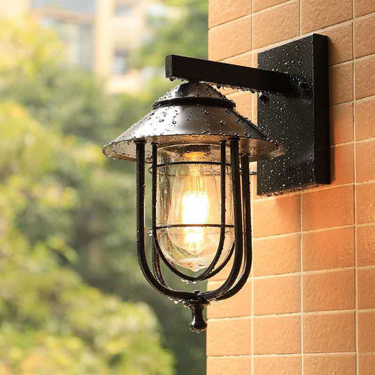 Frendorf | Laterne-förmige Balkon-Wandlampe Lager Metall 1 Kopf Wettergegerbtes Kupfer/schwarz Wandbeleuchtungseinheit mit ovalem klarem Glasschirm