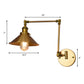 Frendorf | Eine Wandlampe mit einer Kegelschirm-Metall-Industrielampe im Innenbereich in Messing