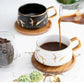Marmormuster Kaffeetasse mit Goldverzierung