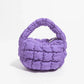 Lebhaftes kreuzgequiltetes rundes Mini-Tasche